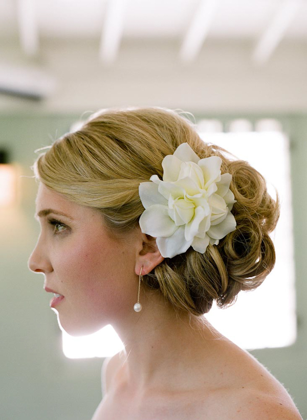 Bridal profile with focus on hair style and white floral hari accessory - wedding photo by top Austin based wedding photographers Q Weddings